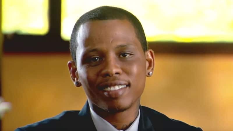 Young man smiling in suit