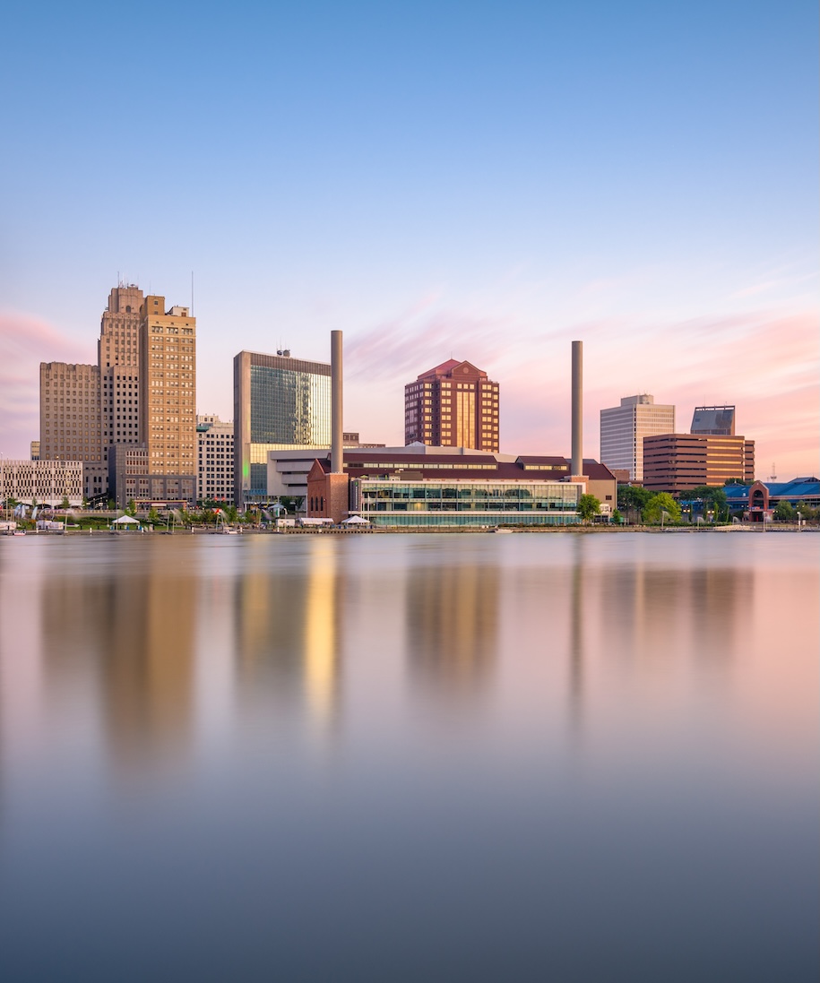 Toledo, Ohio, USA downtown skyline on the Maumee River at dusk.
