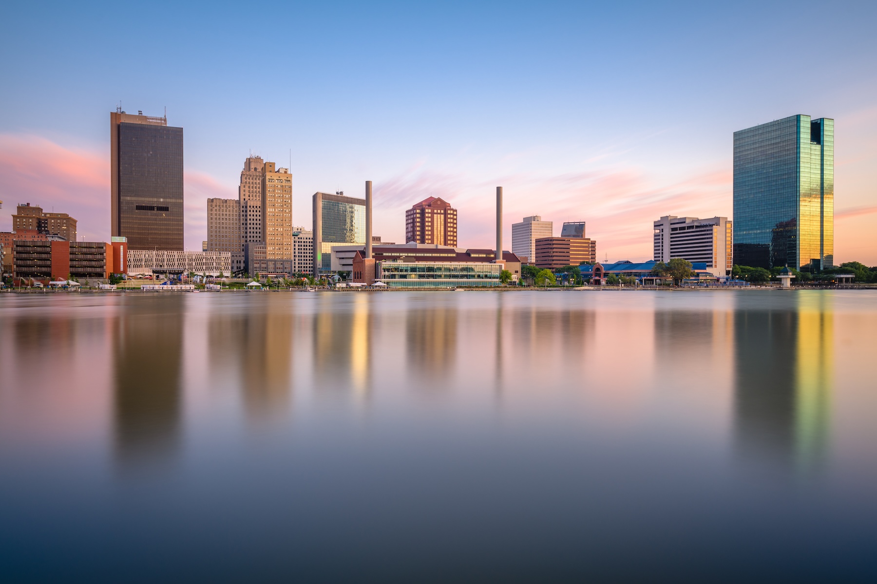 Toledo, Ohio, USA downtown skyline on the Maumee River at dusk.