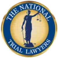 A circular logo with a gold border featuring the image of Lady Justice holding scales and a sword in the center, surrounded by blue bands with the words The National Trial Lawyers.