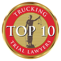 A gold and red badge with the text Trucking Top 10 Trial Lawyers and an image of the Lady Justice holding scales in the center.